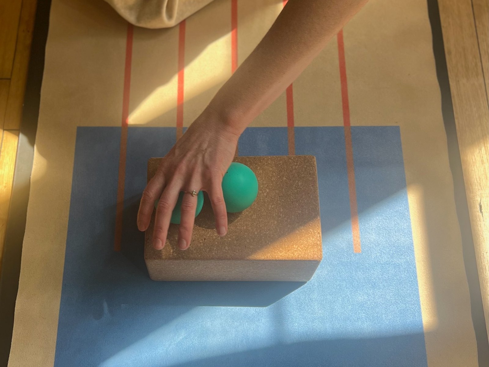 Cork block, therapy ball, and yoga mat in morning light